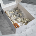 Medium treat box with white chocolate dipped Oreos, pretzel rods, and cake pops